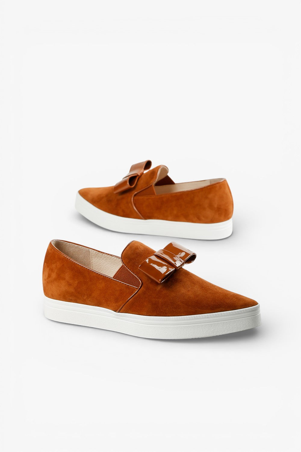 ALL BLACK brown suede slip-on sneaker with glossy patent bow detail and white platform sole, women’s elevated casual comfort shoe for modern fall styling
