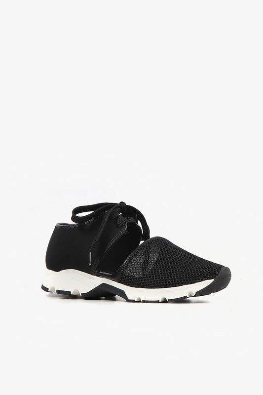 Women's black breathable mesh cutout sneakers with lace-up tie, solid heel counter, and white sporty sole side view