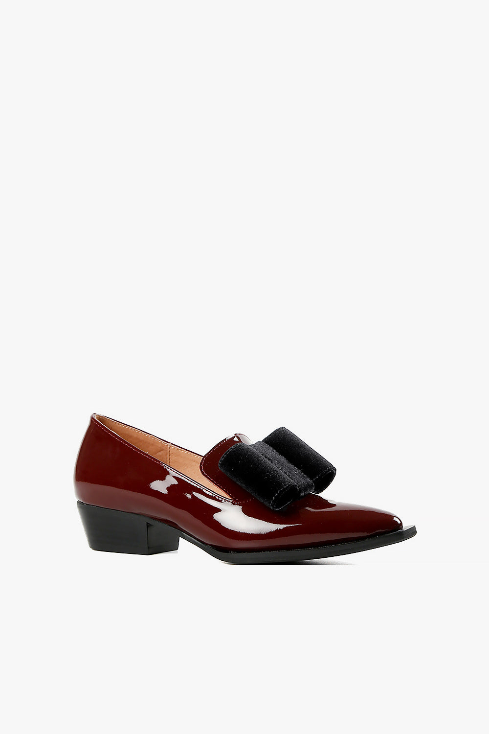 Women's burgundy patent leather low heel loafers with oversized black velvet bow detail, sharp pointed toe, and block heel side view