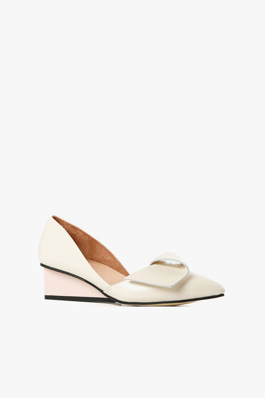 Women's ivory leather d'Orsay pumps with architectural square wedge heel and half-bow detail side view.