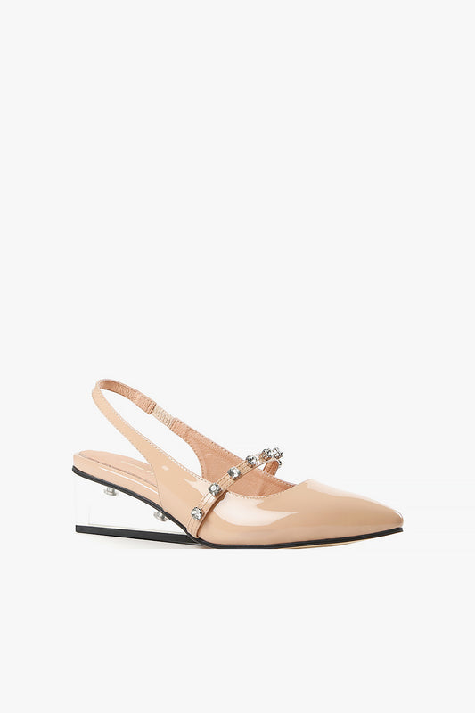Women's nude patent leather slingback pumps with clear architectural wedge heel and crystal-embellished strap side view.