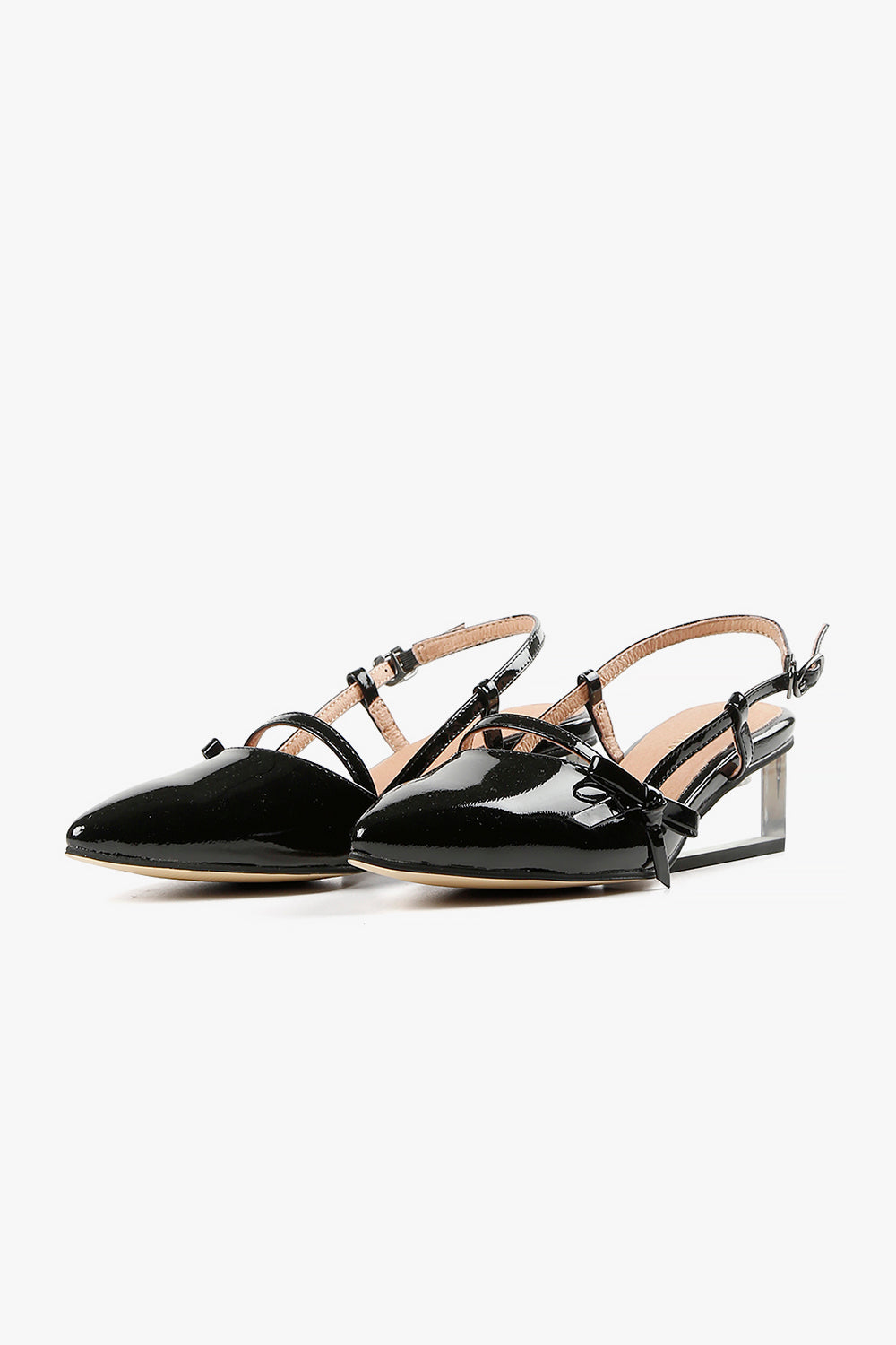 Pair of women's black patent pointed-toe wedges featuring transparent Lucite heels and delicate Mary Jane straps.