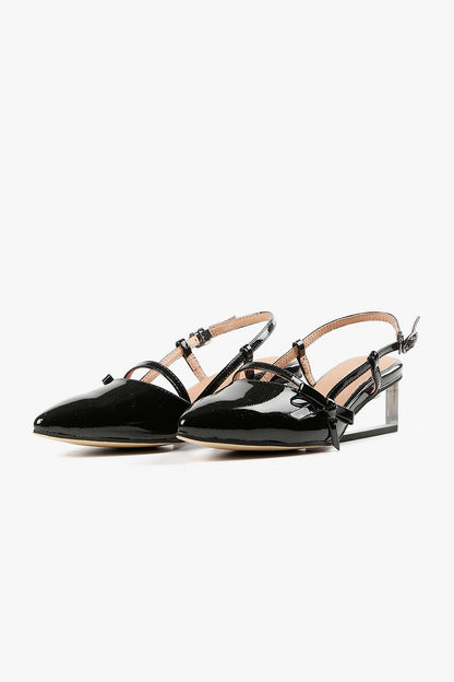 Pair of women's black patent pointed-toe wedges featuring transparent Lucite heels and delicate Mary Jane straps.
