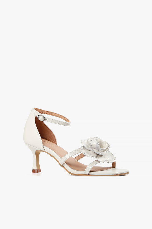 Women's ivory leather kitten heel sandals with a large 3D floral accent and ankle strap side view.