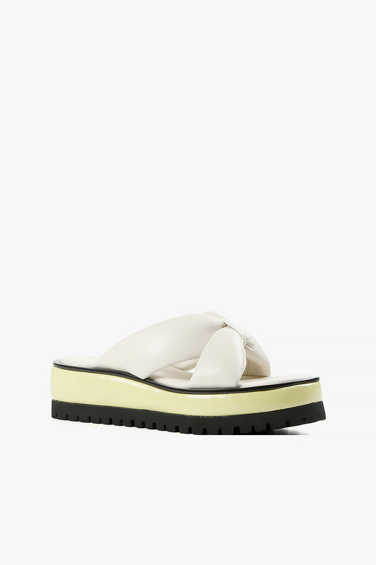 Women's ivory padded leather crossover platform sandals with neon yellow and black lug sole side view.