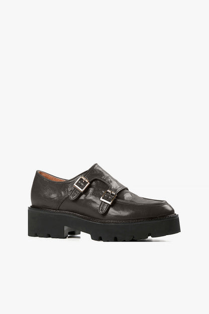 Women's black leather double monk strap loafers with silver buckle details and chunky lug platform sole side view