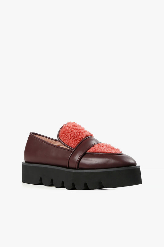 Women's deep plum leather loafers with coral sherpa fleece vamp and chunky black lug platform sole side view