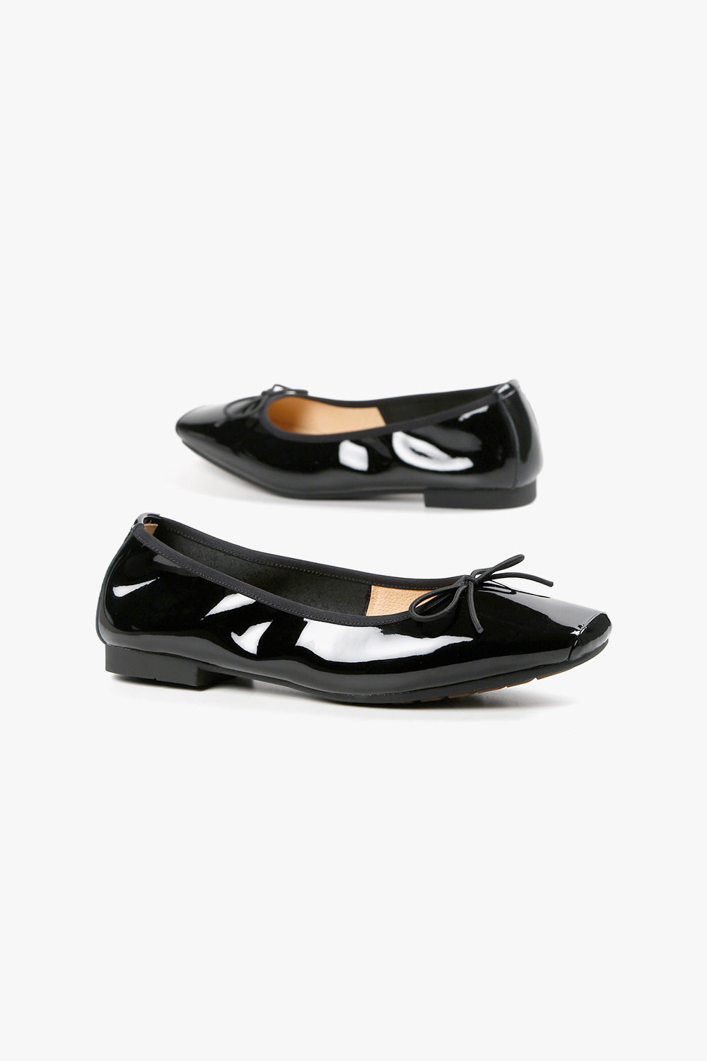 Women's black leather loafer sneakers with chunky platform wedge sole and elastic strap detail.