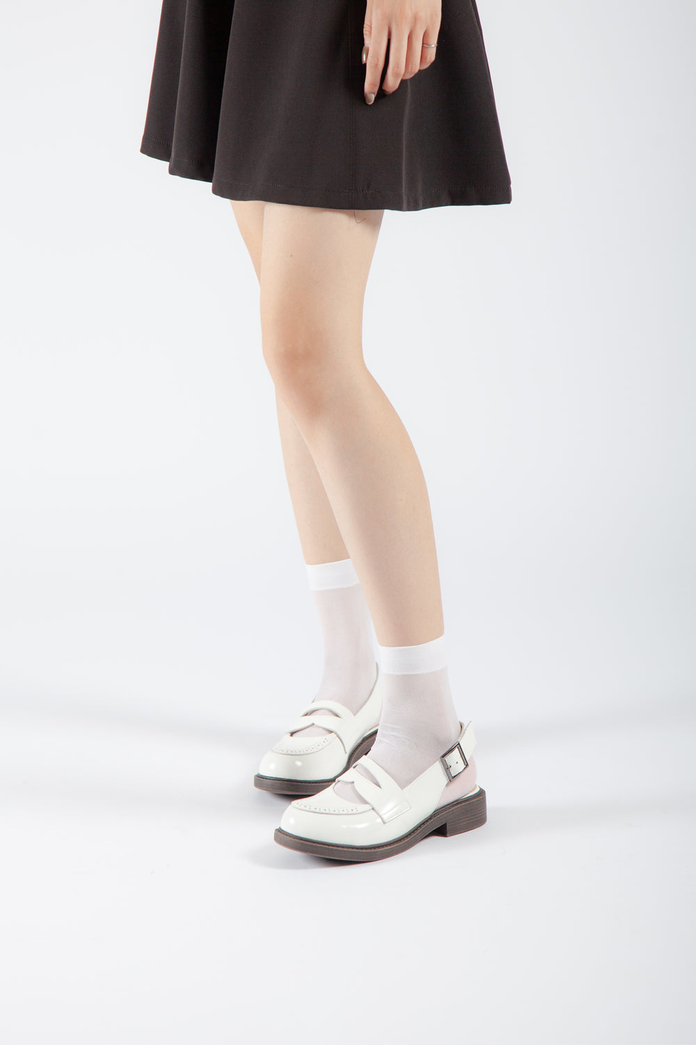 white buckle slingback Mary Jane pumps on model, vintage-inspired low heel dress shoes with feminine styling
