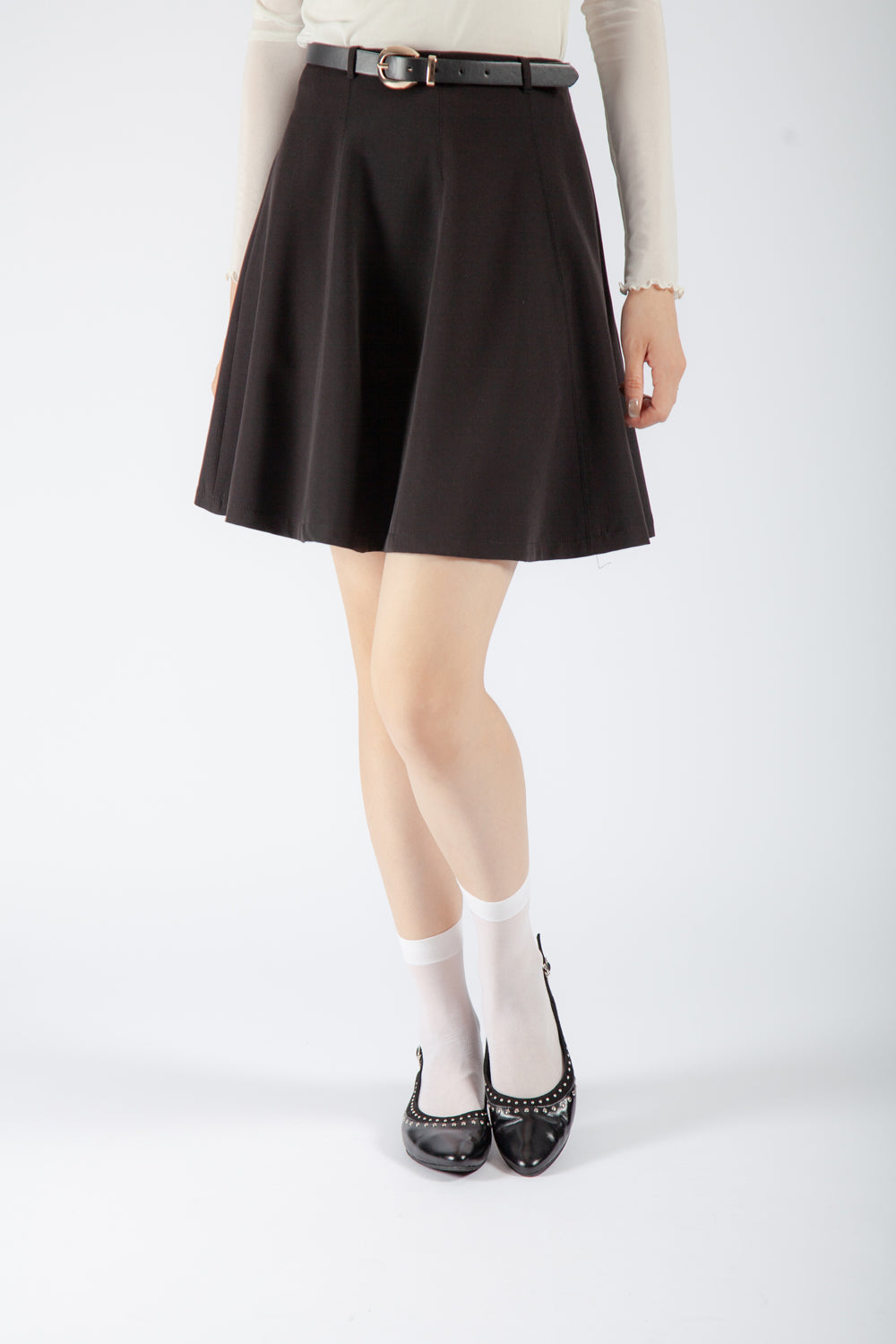 black leather studded slingback flats with pointed toe and silver trim, women’s edgy low heel dress shoes styled with skirt and sheer socks for fall fashion