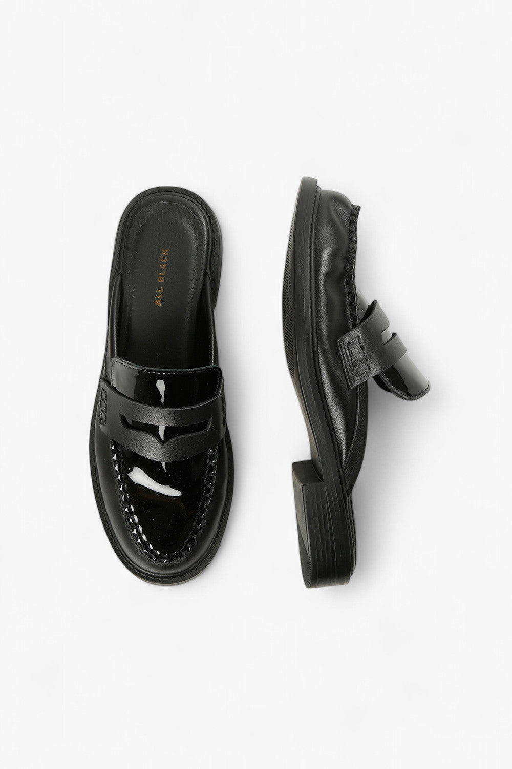 Close-Up of Patent Leather and Penny Loafer Strap Detail on Women’s Black Mules