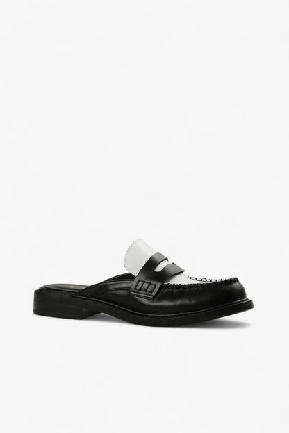  black and white leather penny loafer mule with contrast vamp and moc toe stitching, women’s low heel slip-on dress shoe for modern fall styling