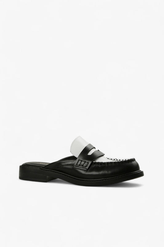  black and white leather penny loafer mule with contrast vamp and moc toe stitching, women’s low heel slip-on dress shoe for modern fall styling