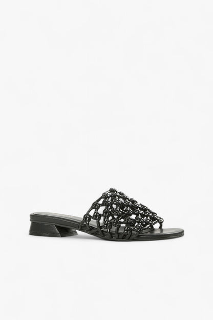 Women's black woven leather slide sandals with low geometric block heel side view.