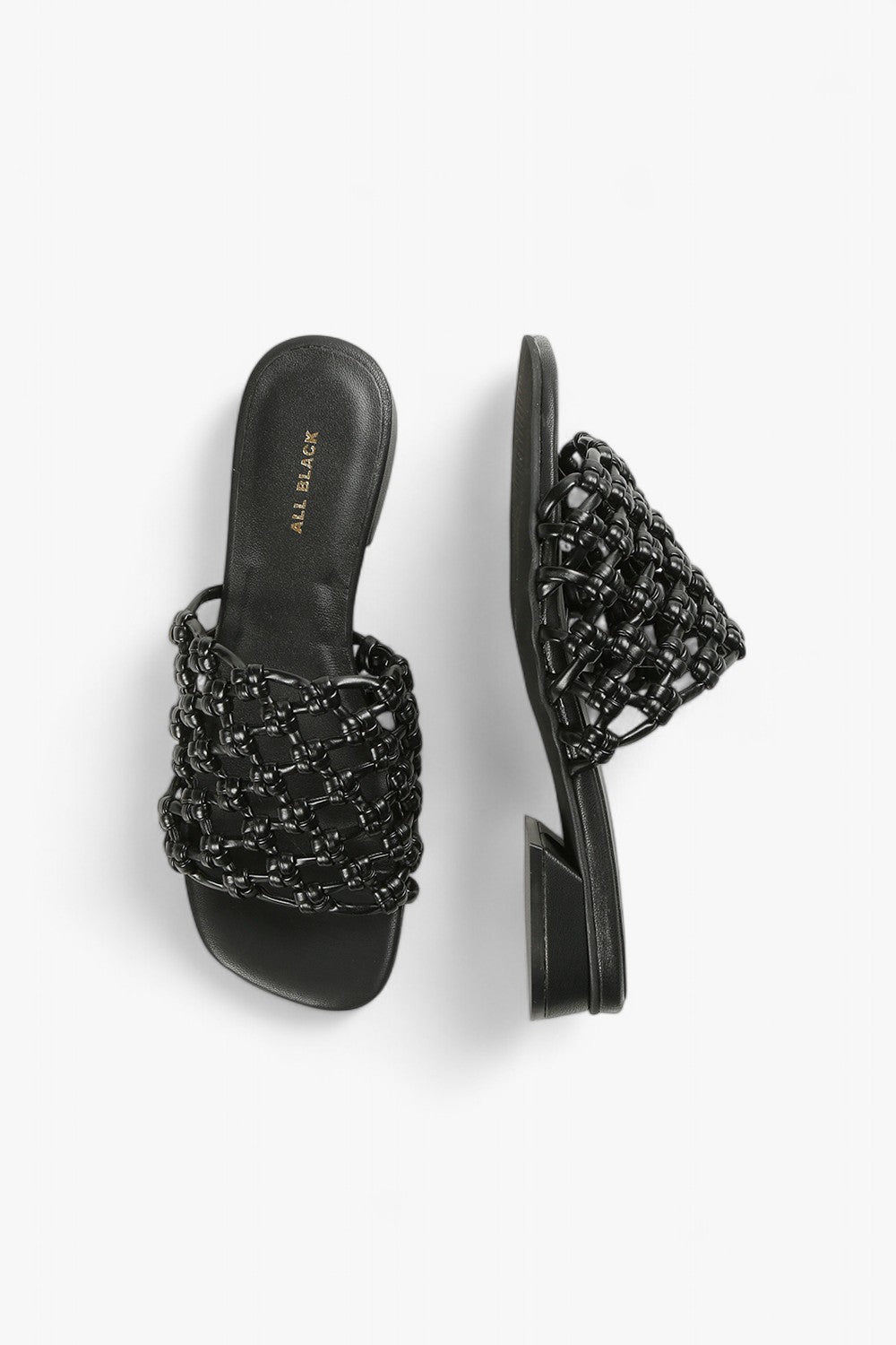 Top down and side view of women's black woven slides, showcasing the architectural heel and texture.