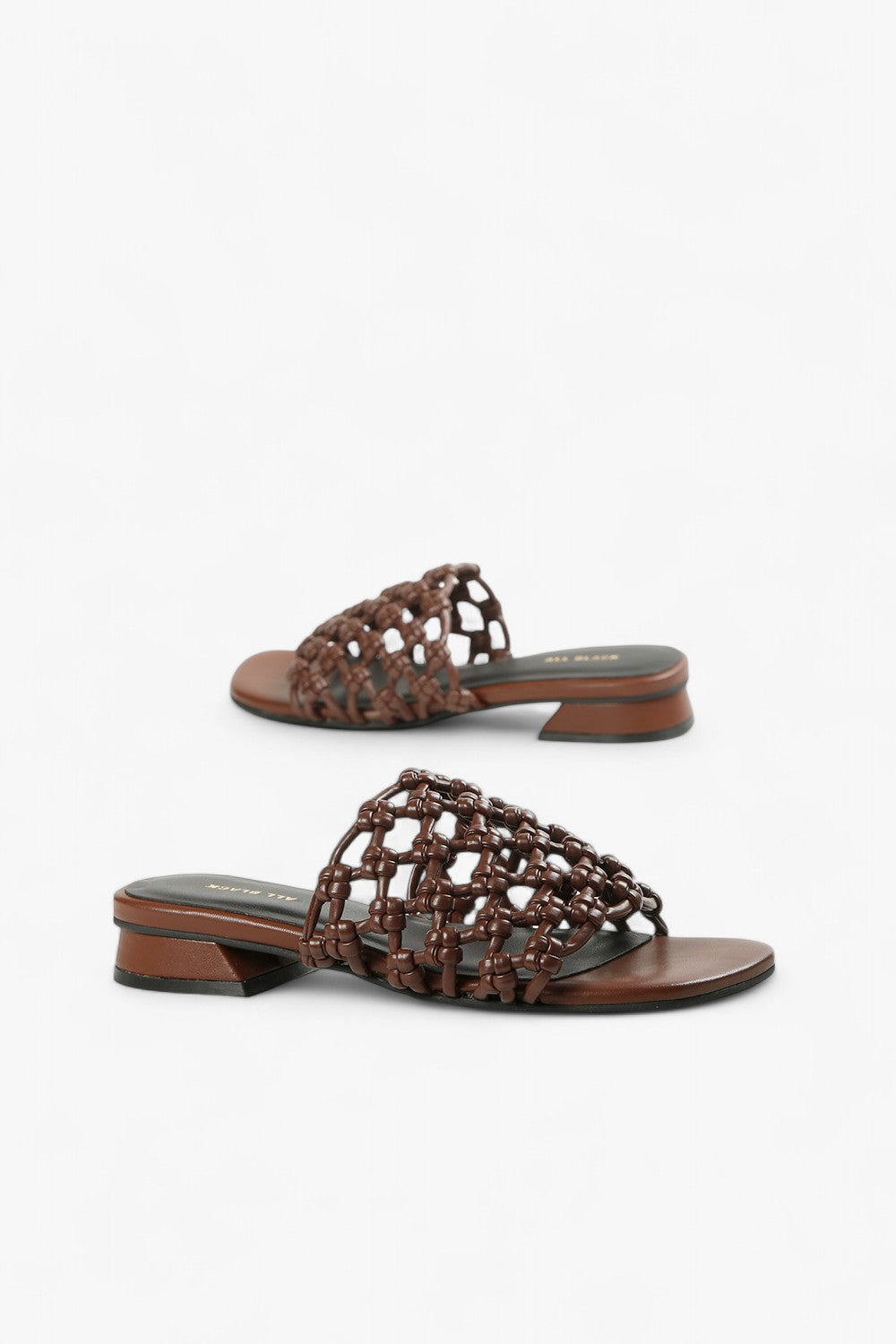 Pair of women's dark brown leather slides featuring an intricate 3D square weave strap.