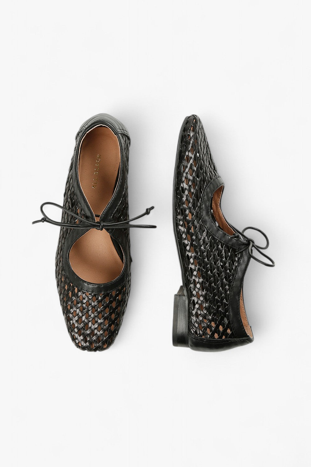 Top and side view of women's black woven leather dress shoes showcasing the artistic cutout pattern and tan lining.