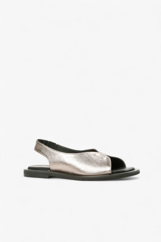 Women's metallic pewter leather peep-toe sandals with asymmetrical slingback strap and black flat sole side view.