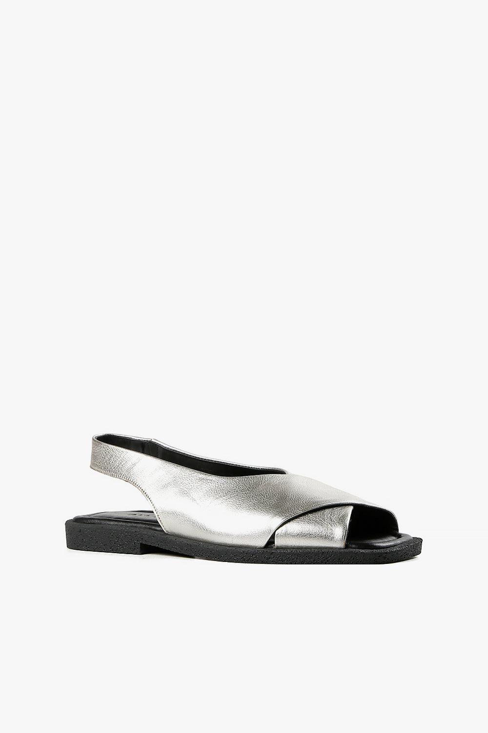 Women's silver metallic leather criss-cross sandals with backstrap and chunky black textured sole side view.
