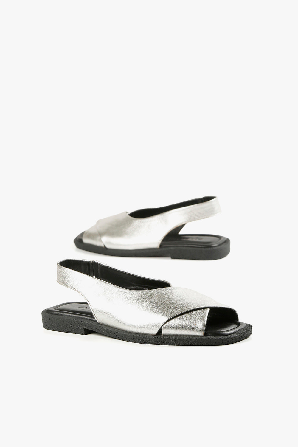 Women's silver leather fashion sandals with elastic slingback strap and cushioned black footbed.