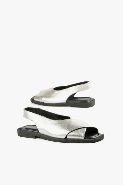Women's silver leather fashion sandals with elastic slingback strap and cushioned black footbed.
