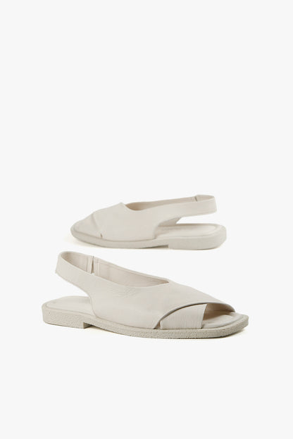 Women's all-white fashion sandals with elastic backstrap and cushioned ergonomic footbed.