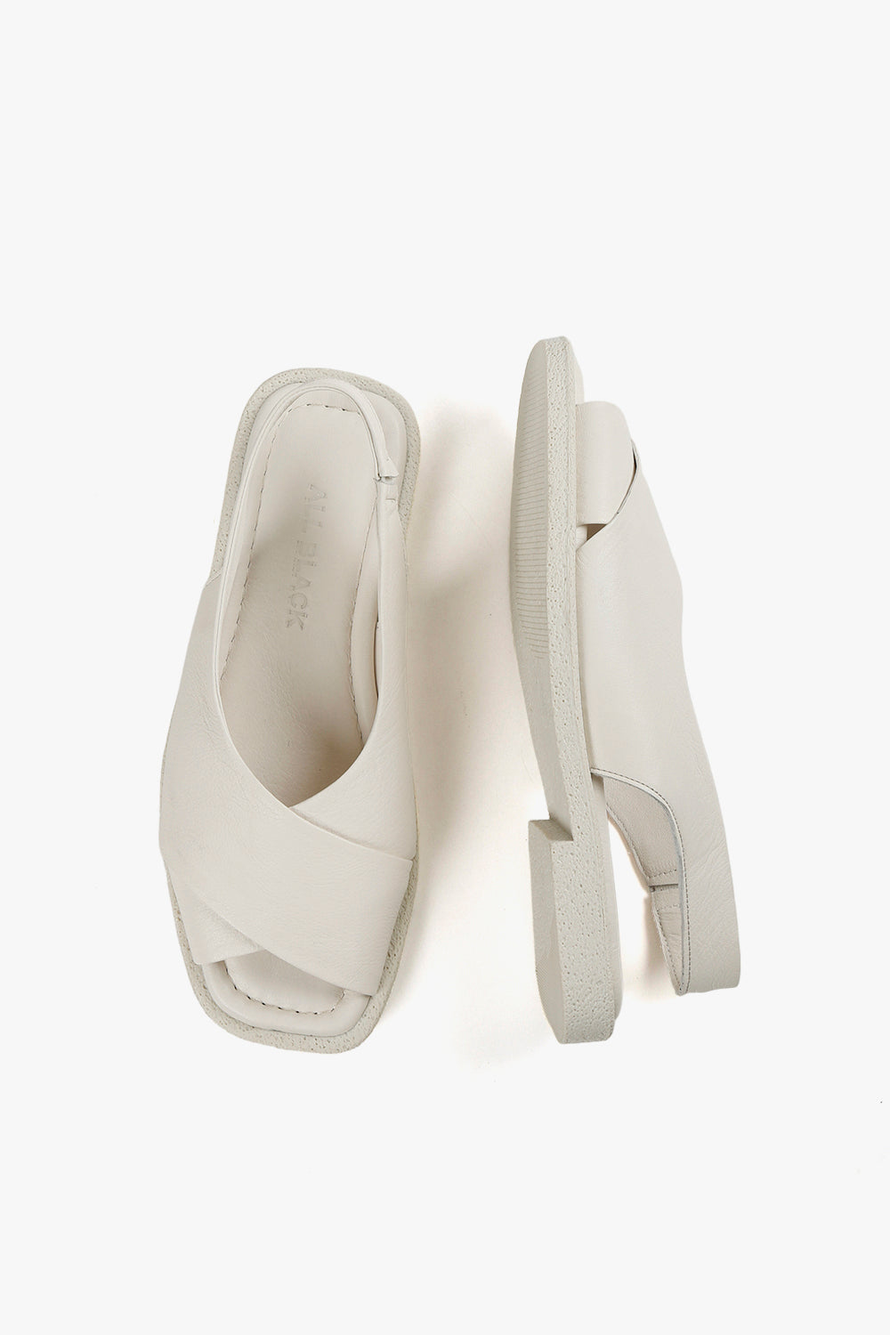 Top down and side view of women's white leather crossover sandals showcasing square toe design and grainy rubber outsoles.