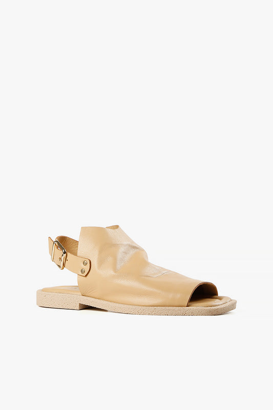 Women's sand leather open-toe slingback sandals with adjustable buckle strap and textured rubber sole side view.