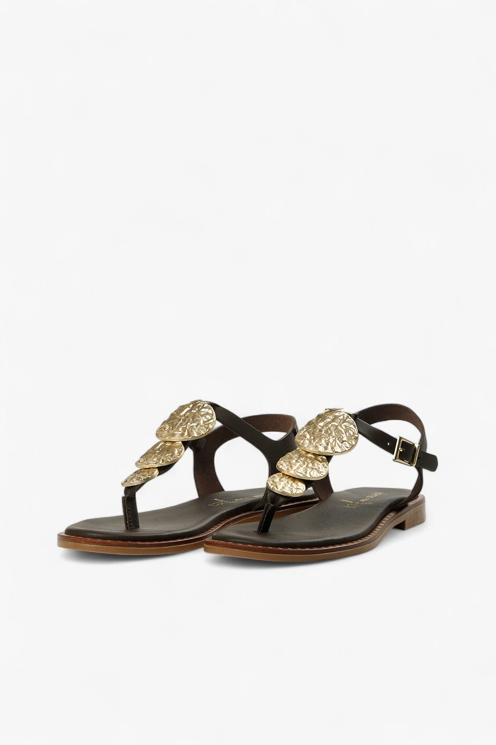 Top down view of women's dark brown T-strap sandals with gold hammered coin accents and gold ALL BLACK logo.
