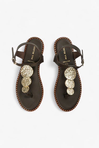 Pair of women's leather marron sandals showcasing the metallic gold medallions and natural leather lining.